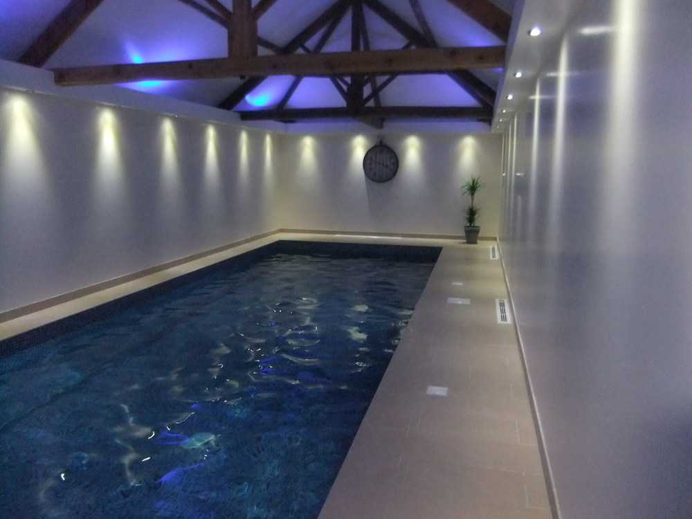 The finished swimming pool with hidden coloured up lighting and LED down lights